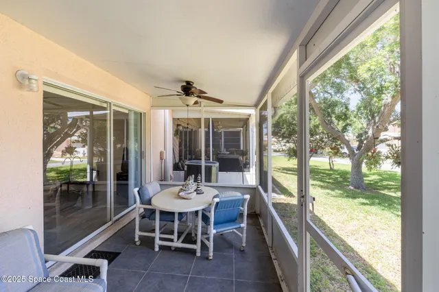 a dining room with furniture a chandelier and glass door