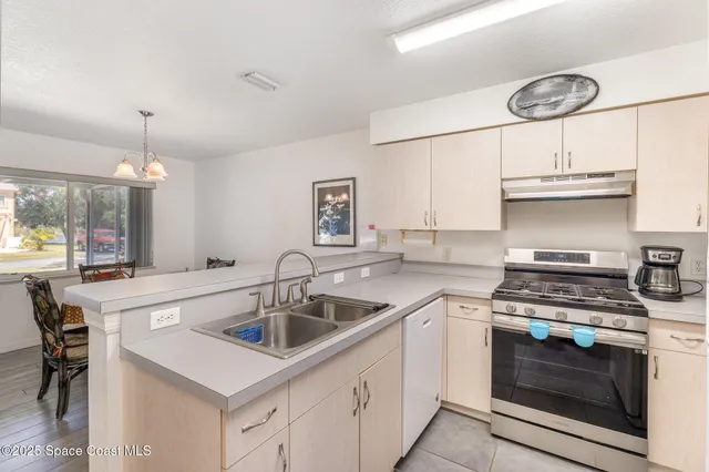 a kitchen with cabinets a sink and appliances