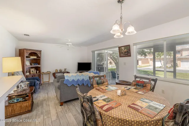 a living room with furniture a flat screen tv and a large window