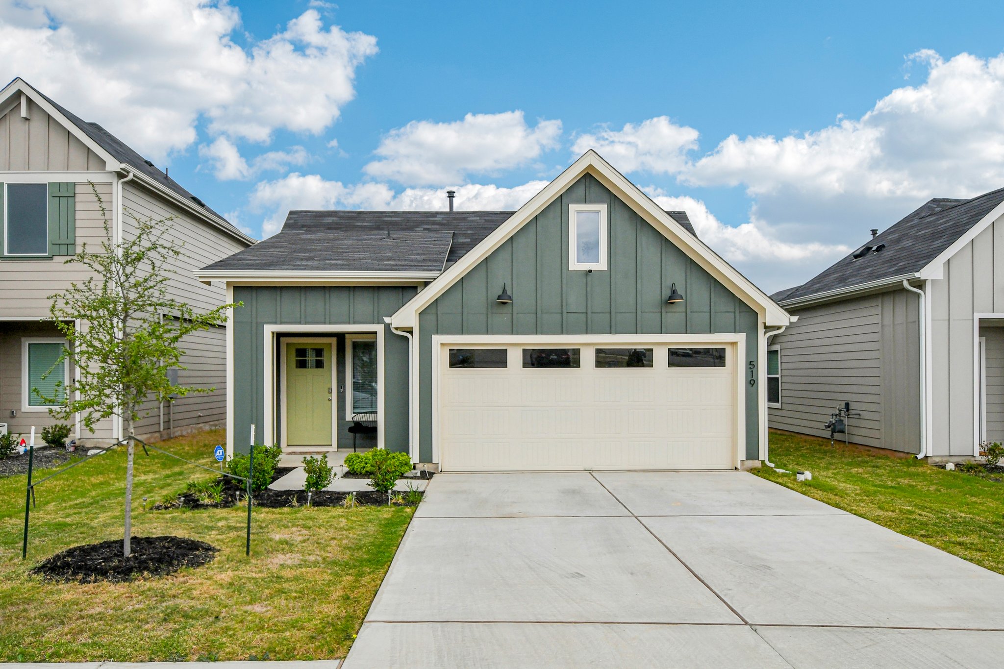 519 Sandringham Loop Kyle, TX 78640 - Photo 2 of 32 View of front facade with board and batten siding, a front yard, driveway, and a shingled roof