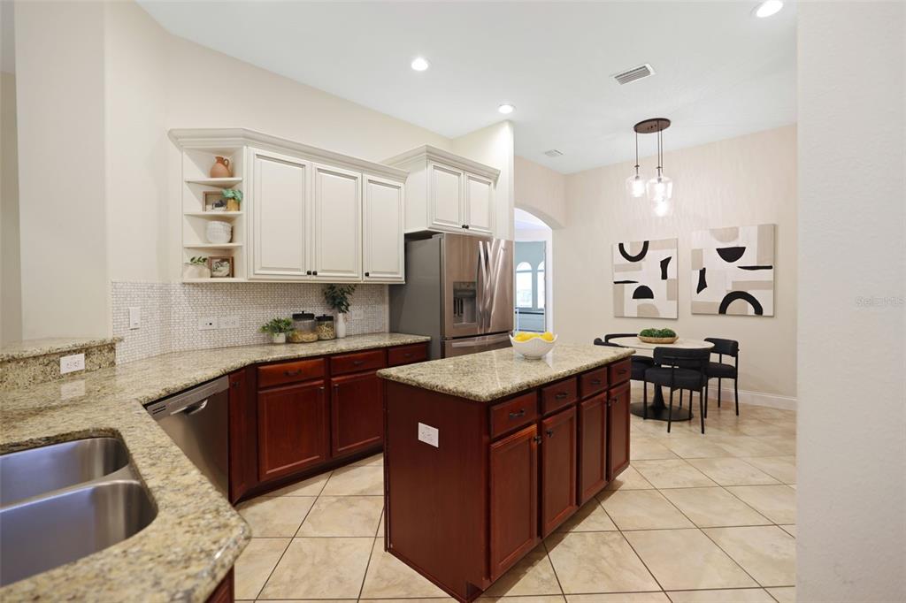 27211 Hawks Nest Circle Wesley Chapel, FL 33544 - Photo 16 of 58 a kitchen with stainless steel appliances granite countertop a sink counter space and a refrigerator