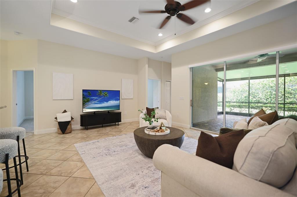 27211 Hawks Nest Circle Wesley Chapel, FL 33544 - Photo 20 of 58 a living room with furniture a ceiling fan and a large window