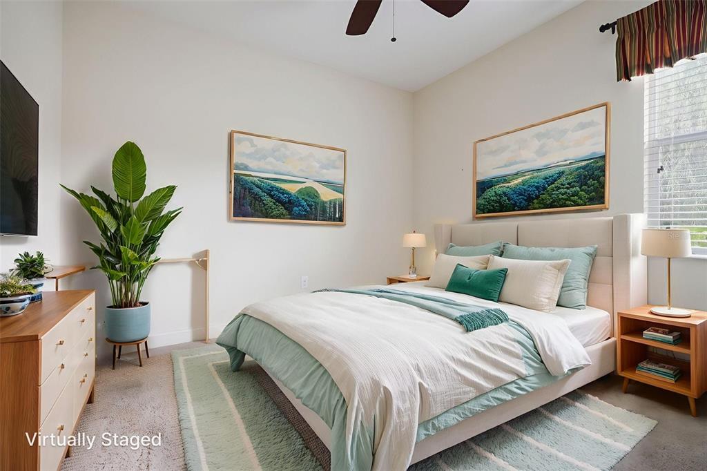 27211 Hawks Nest Circle Wesley Chapel, FL 33544 - Photo 34 of 58 a bedroom with bed and a potted plant