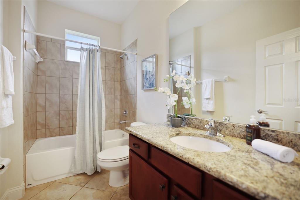 27211 Hawks Nest Circle Wesley Chapel, FL 33544 - Photo 35 of 58 a bathroom with a granite countertop sink toilet and shower