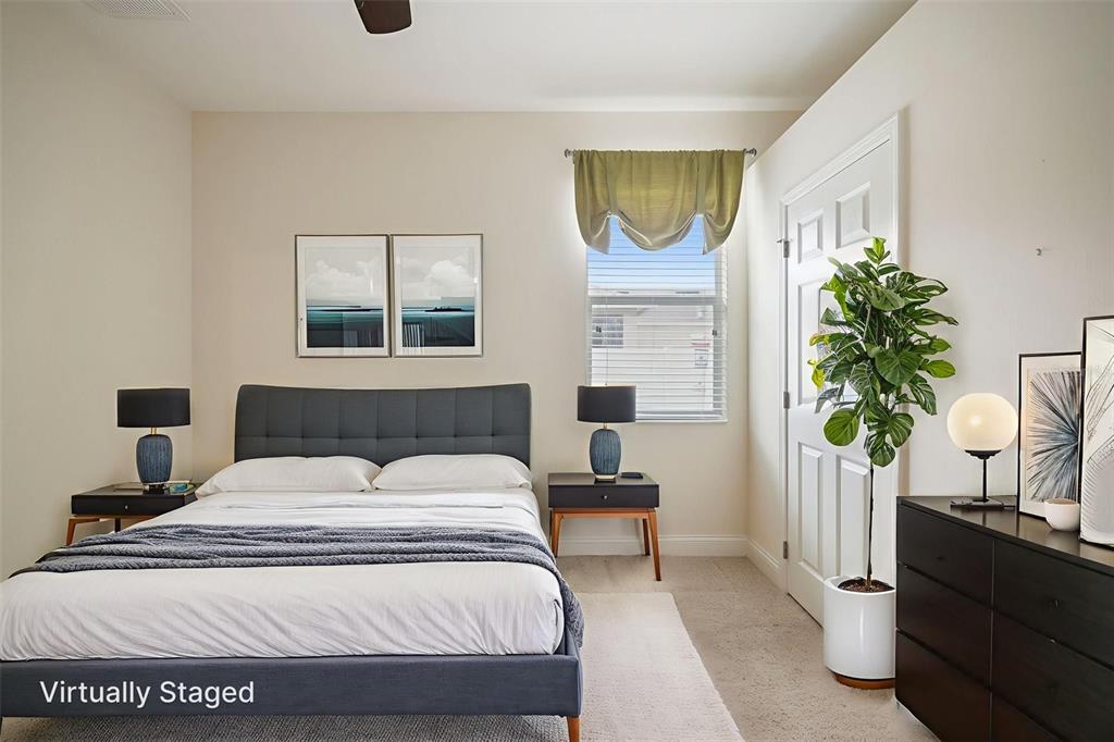 27211 Hawks Nest Circle Wesley Chapel, FL 33544 - Photo 36 of 58 a bedroom with a bed and a potted plant