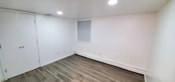 a view of room with wooden floor