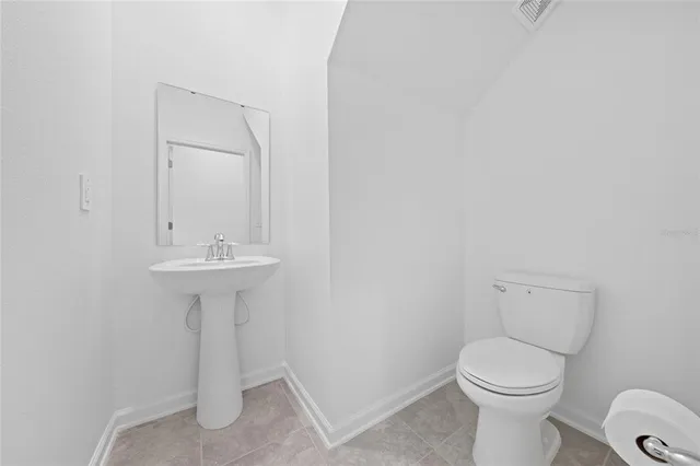 a bathroom with a sink toilet and a mirror
