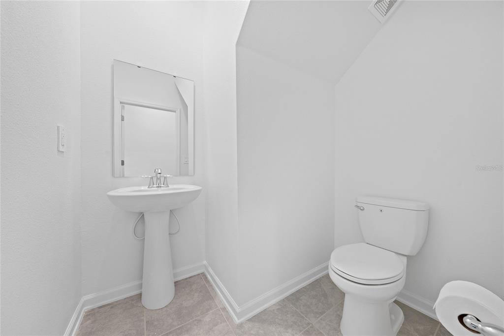 6061 Shavasana Road Clermont, FL 34714 - Photo 11 of 33 a bathroom with a sink toilet and a mirror