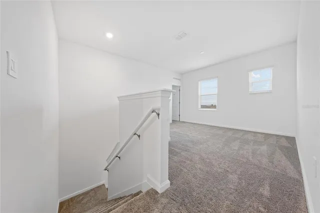 a view of an empty room with stairs