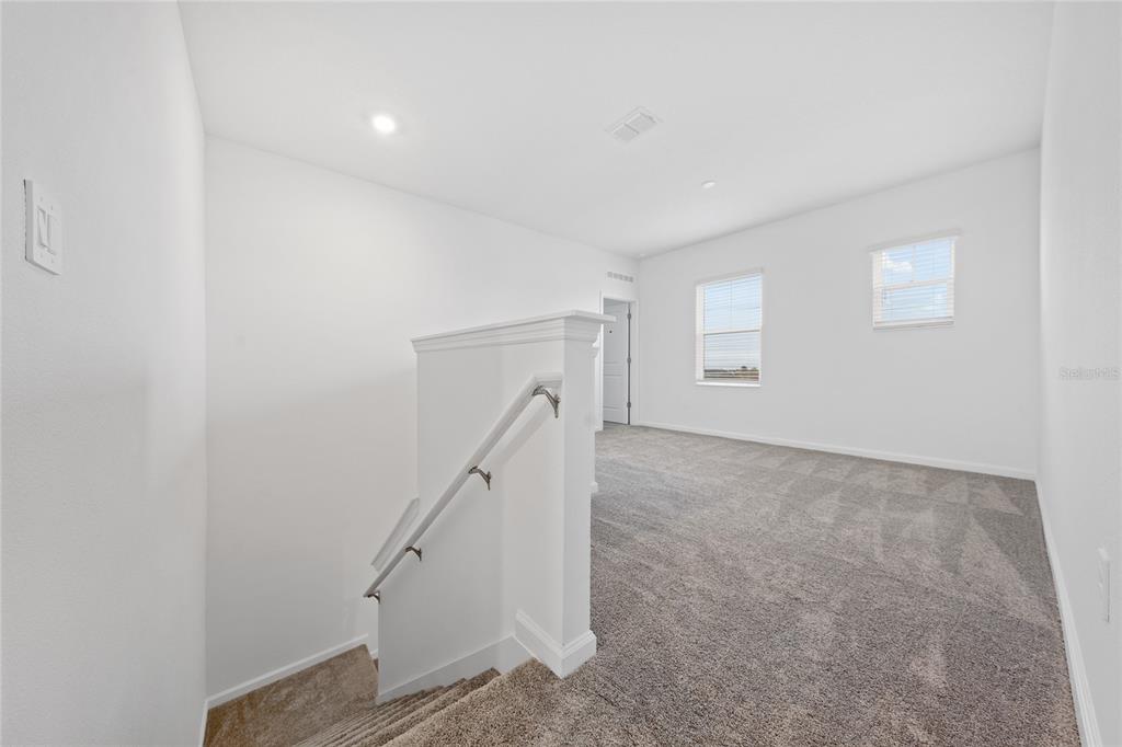 6061 Shavasana Road Clermont, FL 34714 - Photo 12 of 33 a view of an empty room with stairs
