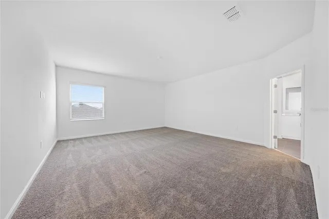 a view of an empty room and a window