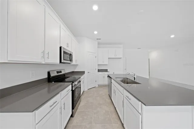 a kitchen with a sink and cabinets