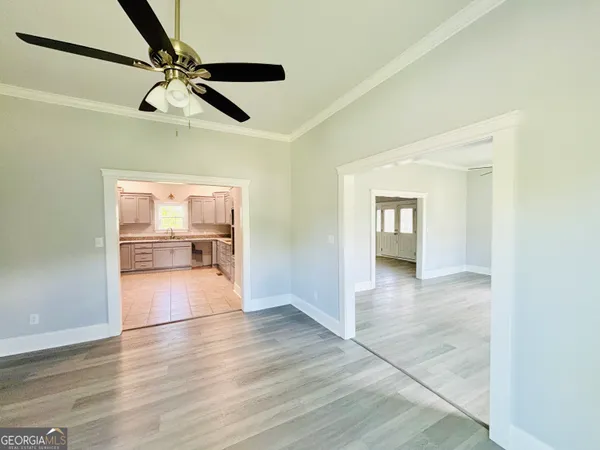 a view of empty room with wooden floor