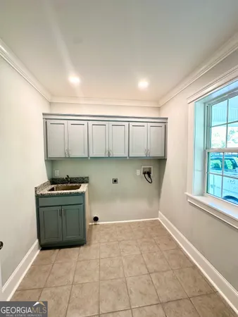 a kitchen with granite countertop a stove a sink and a granite counter tops