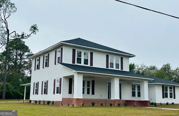 a front view of a house with a yard