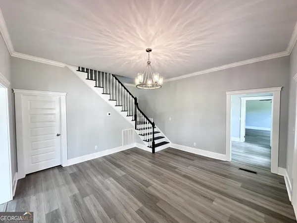 a view of entryway and hall with wooden floor