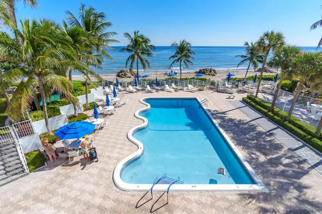 a view of swimming pool with outdoor seating
