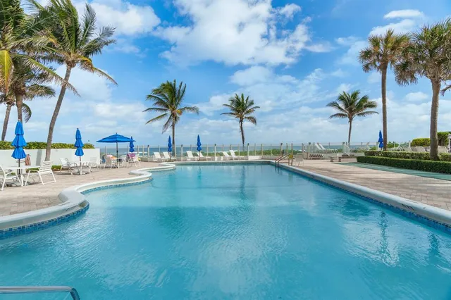 a view of outdoor space with swimming pool and lounge chair