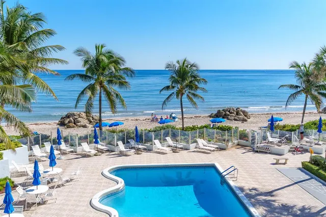 a swimming pool with outdoor seating and yard