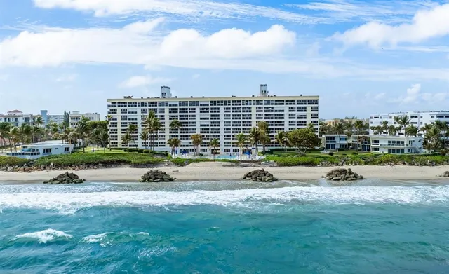 a view of swimming pool with outdoor seating and city view
