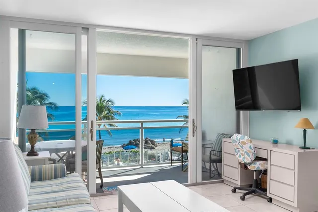 a room with a chair and a flat screen tv