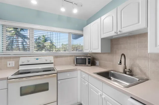 a kitchen with appliances cabinets and a sink
