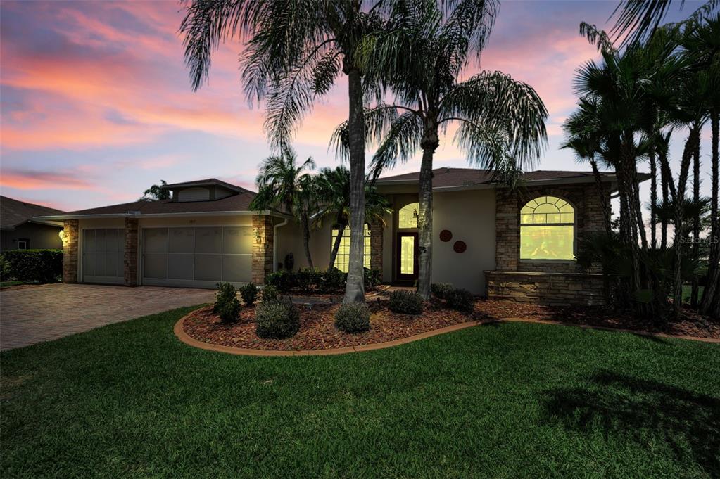 11917 Hadleigh Way Trinity, FL 34655 - Photo 84 of 84 a view of a backyard with table and chairs potted plants and palm tree