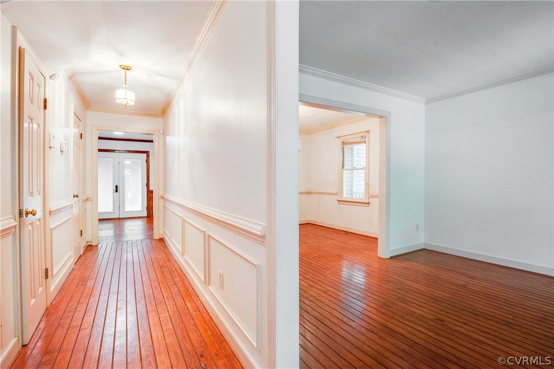 8403 Spring Meadow Road Richmond, VA 23235 - Photo 4 of 19 a view of a hallway with wooden floor and a bathroom