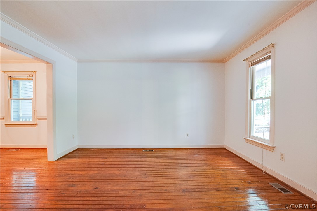 8403 Spring Meadow Road Richmond, VA 23235 - Photo 5 of 19 an empty room with wooden floor and windows