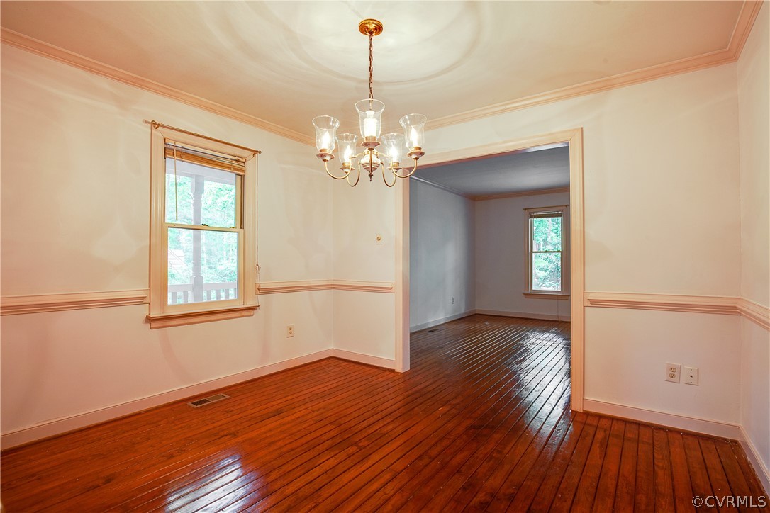8403 Spring Meadow Road Richmond, VA 23235 - Photo 6 of 19 a view of a room with wooden floor chandelier and windows