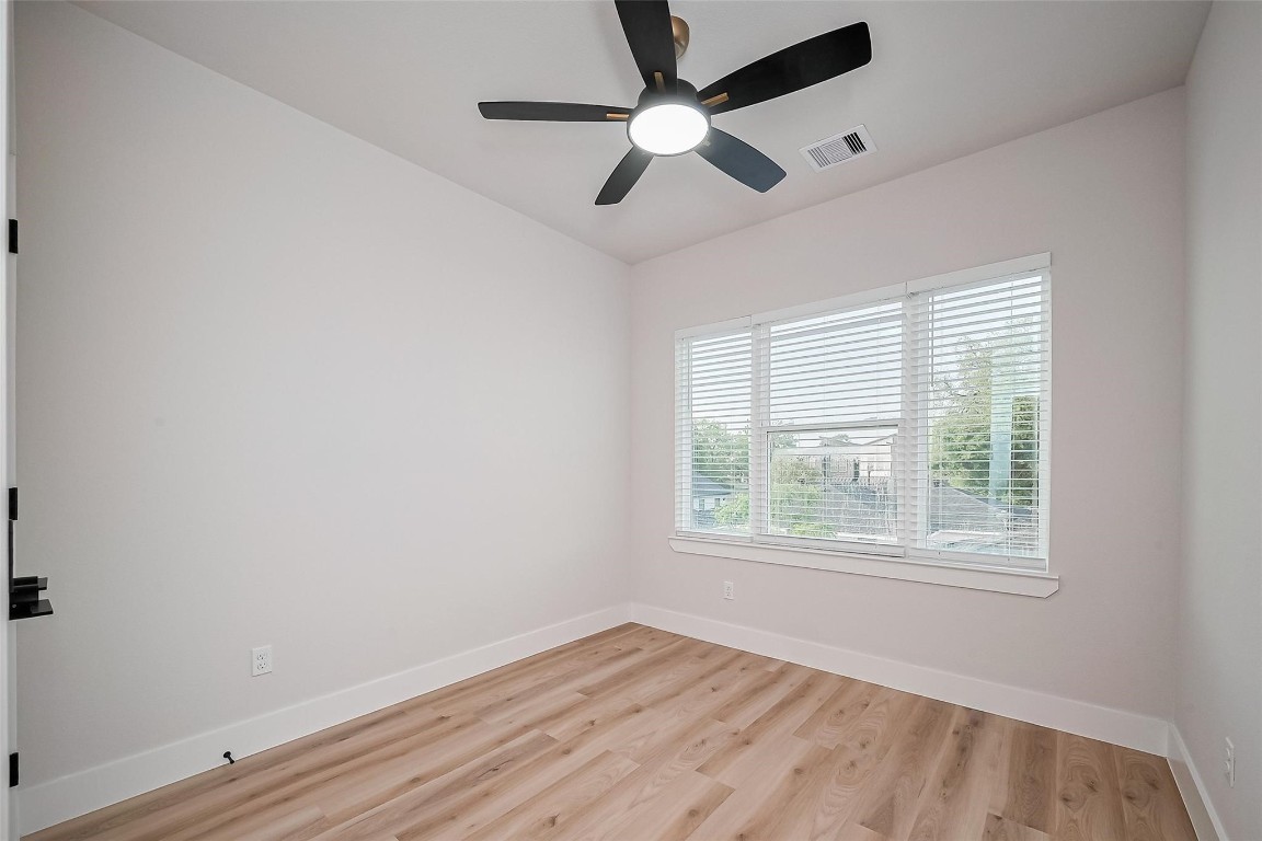 3542 Mt Pleasant Street Houston, TX 77021 - Photo 12 of 17 a view of an empty room with wooden floor and a window