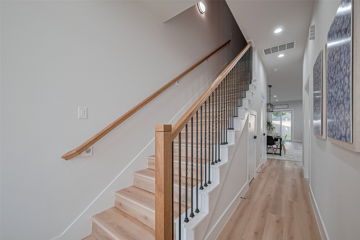 3542 Mt Pleasant Street Houston, TX 77021 - Photo 16 of 17 a view of a hallway with wooden floor and staircase