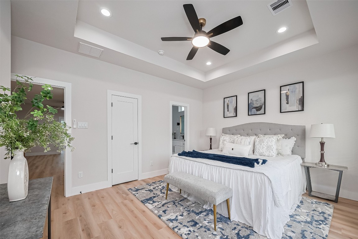 3542 Mt Pleasant Street Houston, TX 77021 - Photo 8 of 17 a bedroom with a large bed and a chandelier