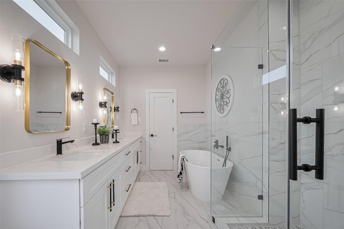3542 Mt Pleasant Street Houston, TX 77021 - Photo 9 of 17 a spacious bathroom with a double vanity sink a mirror and shower
