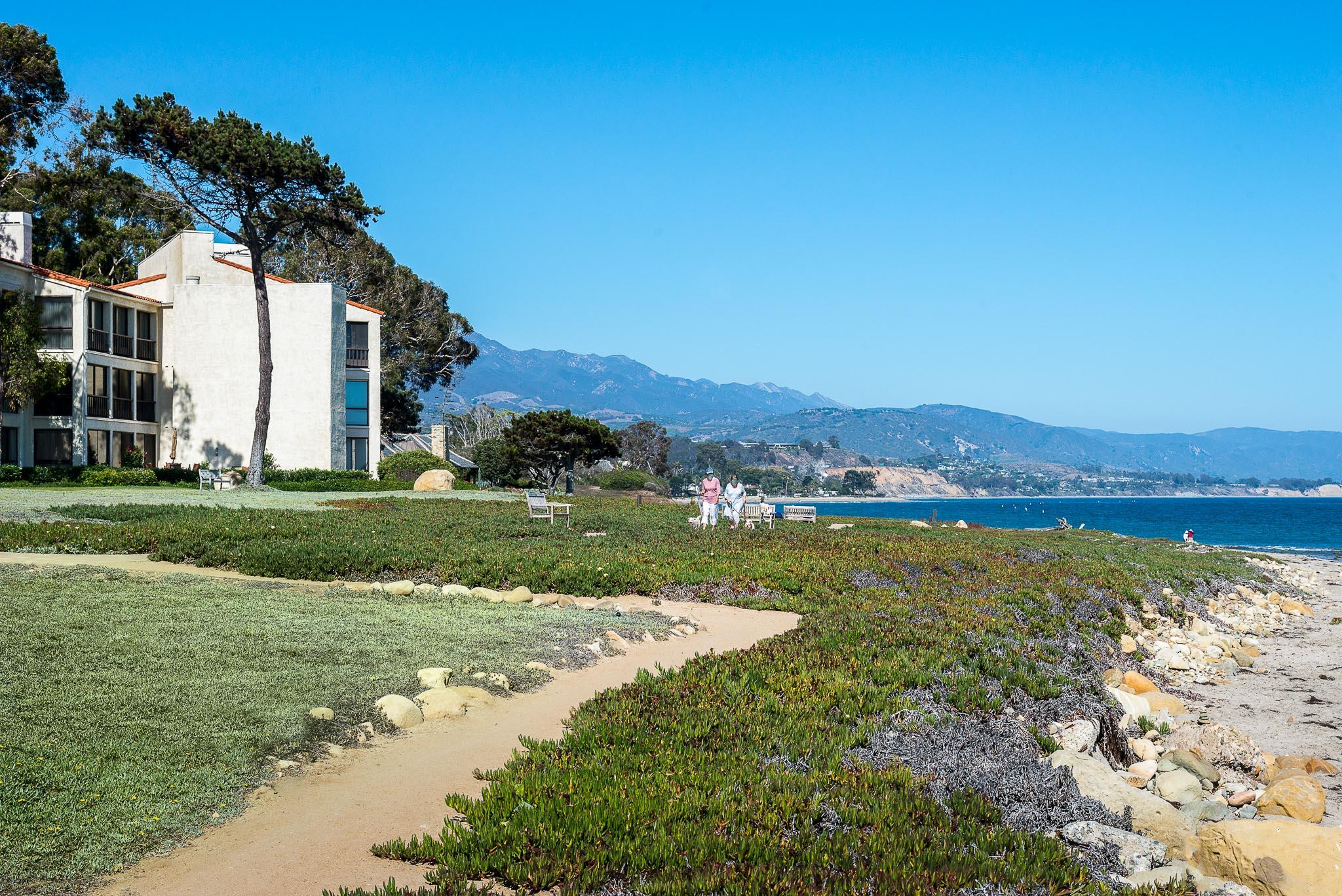 26 Seaview Drive Santa Barbara, CA 93108 - Photo 21 of 26 a view of a white house in front of a big yard with plants and large trees