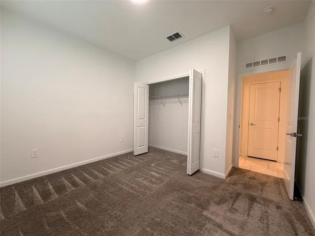 an empty room with closet area