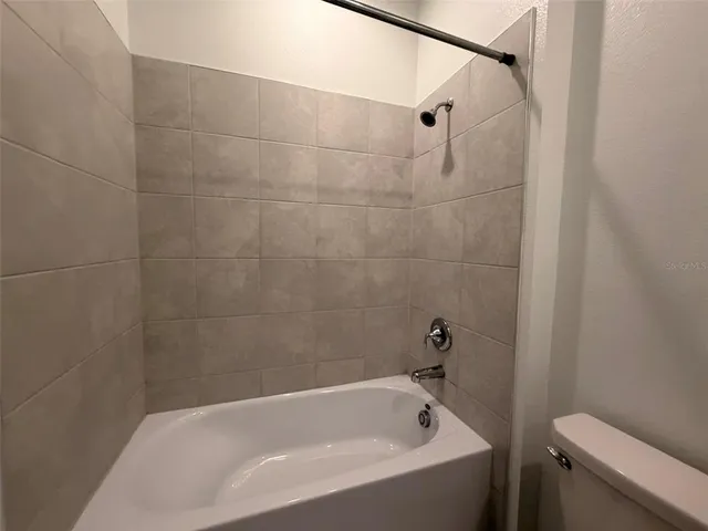 a bathroom with a bathtub and a toilet
