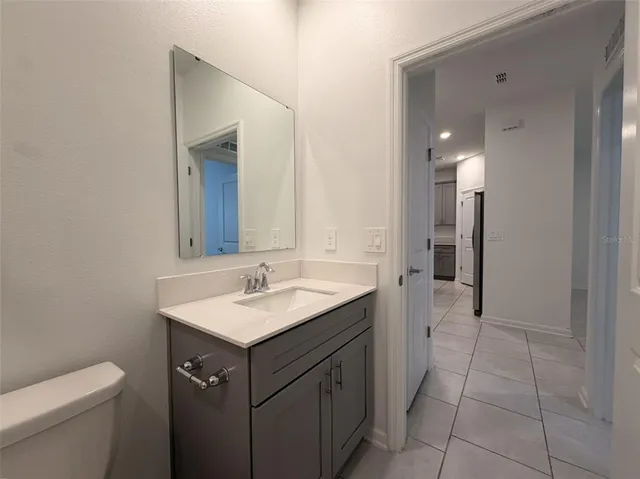 a bathroom with a sink toilet and mirror