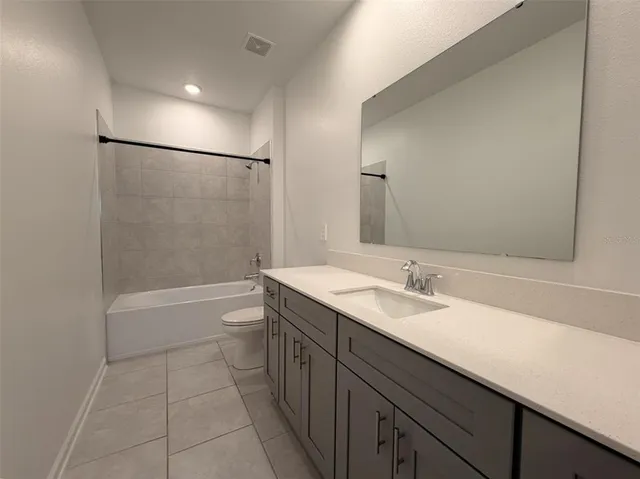 a white toilet sitting next to a bath tub