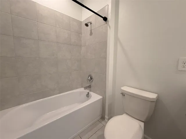a bathroom with a white bath tub and a shower