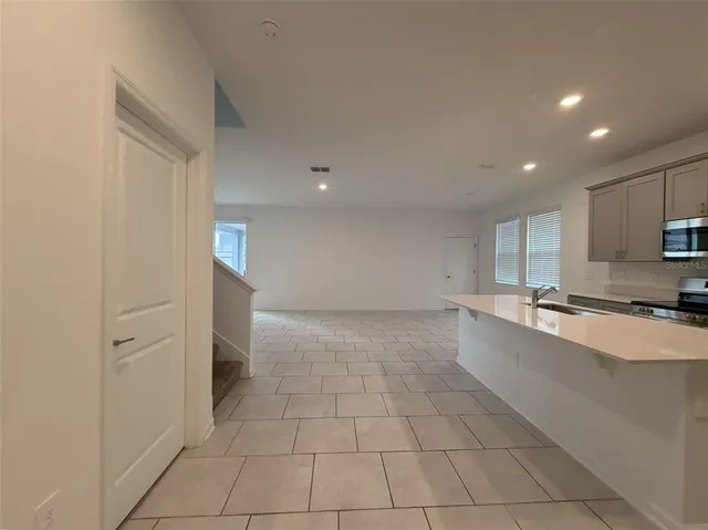 a large kitchen with a sink and cabinets