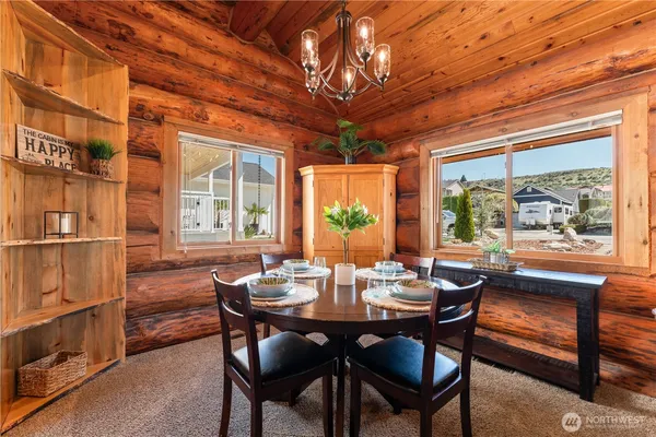 a dining room with furniture a rug and a large window