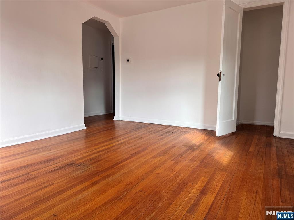567 Boulevard, Unit 2 Hasbrouck Heights, NJ 07604 - Photo 3 of 7 an empty room with wooden floor and entrance