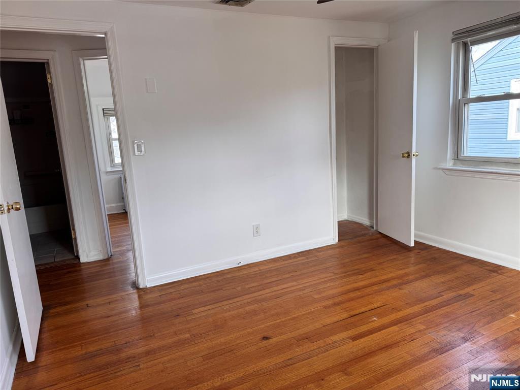567 Boulevard, Unit 2 Hasbrouck Heights, NJ 07604 - Photo 7 of 7 an empty room with wooden floor and a window