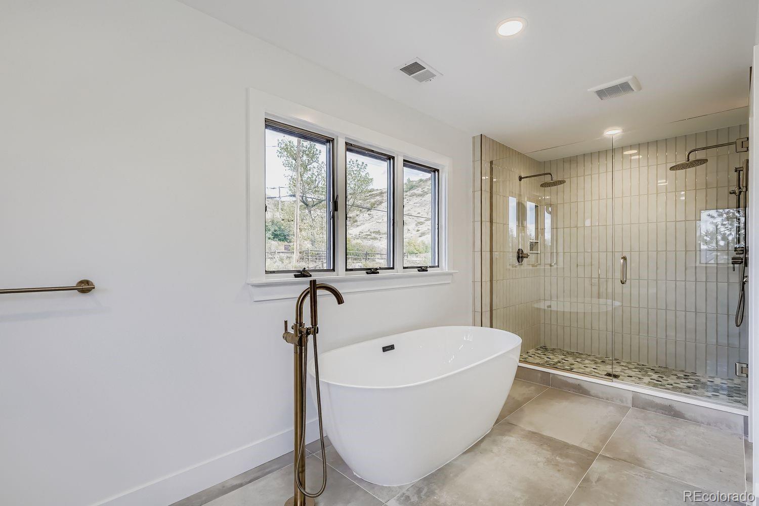 2127 Elderberry Road Golden, CO 80401 - Photo 12 of 43 a bathroom with a bathtub and shower