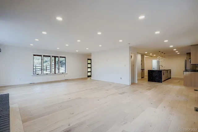 a view of an empty room with a kitchen