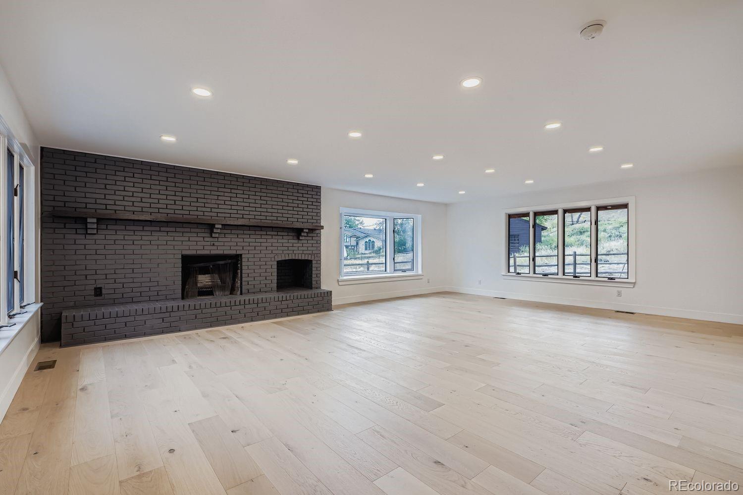 2127 Elderberry Road Golden, CO 80401 - Photo 15 of 43 an empty room with windows and fireplace