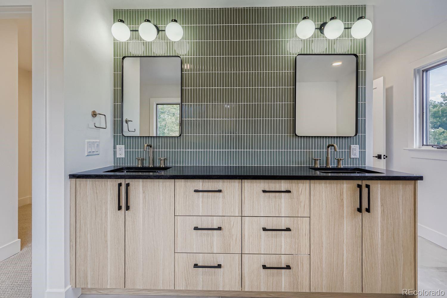 2127 Elderberry Road Golden, CO 80401 - Photo 19 of 43 a bathroom with a sink vanity and mirror