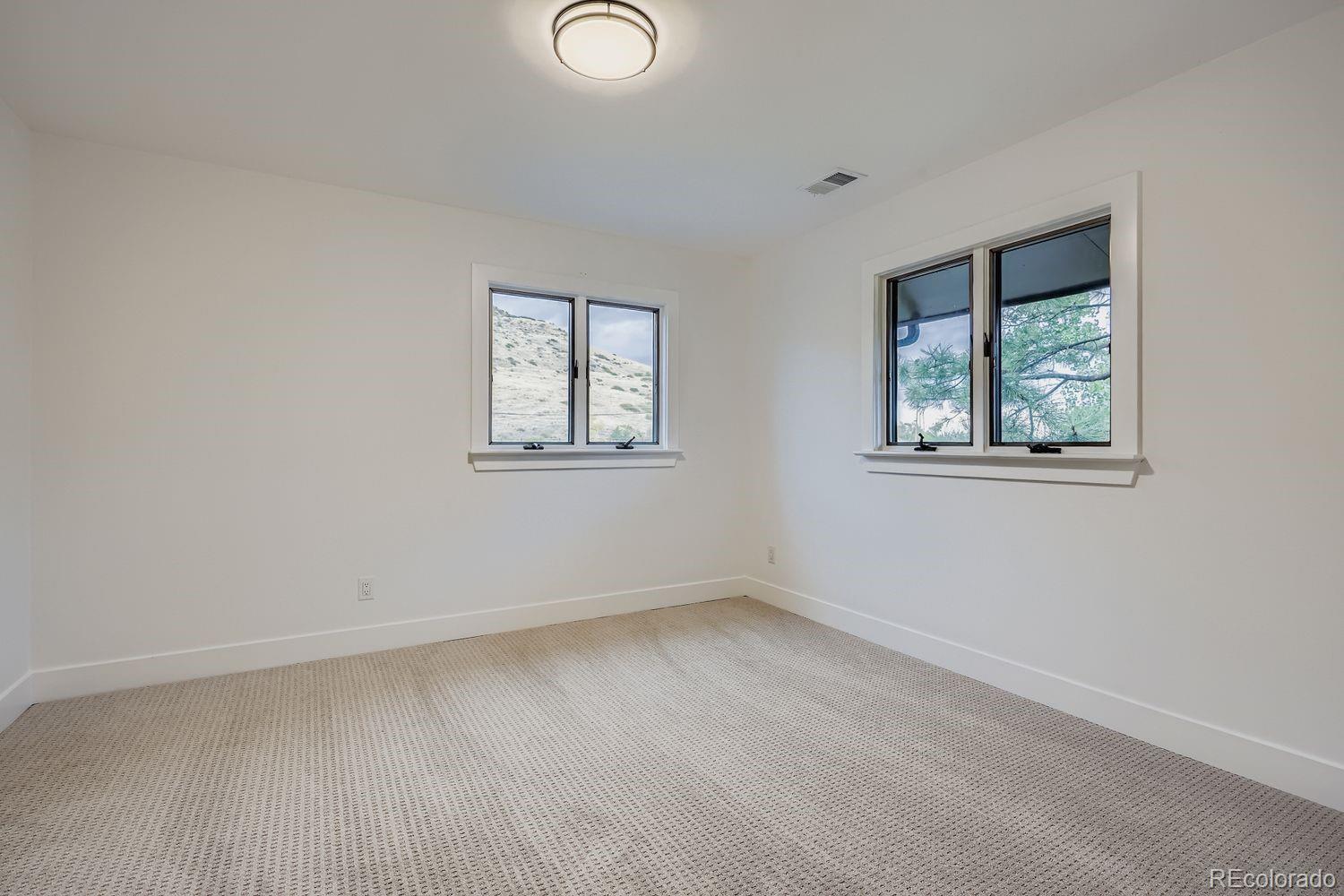 2127 Elderberry Road Golden, CO 80401 - Photo 21 of 43 an empty room with windows