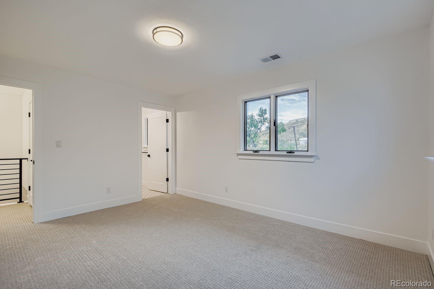 2127 Elderberry Road Golden, CO 80401 - Photo 22 of 43 an empty room with windows and closet